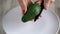 Woman cuts avocado. The concept of modern healthy eating
