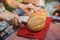 The woman cuts bread on wooden board