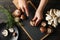 Woman cuts champignon on cutting board with mushrooms