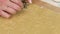 Woman cuts cookie dough. With a snowflake shape. Cooking marshmallow sandwiches. Close-up shot