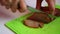 The woman cuts the dried chicken with a knife. Preparation of dried chicken fillet.