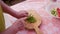 Woman cuts with a knife greens for salad on a cutting Board. Great plan from the top. Close up.