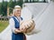 Woman cuts loaf of large bread on wooden table