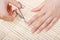 Woman cuts nails scissors