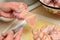 Woman cuts off excess chicken skin