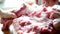 Woman cuts pork carcass into pieces