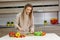 Woman cuts ripe vegetables in the kitchen