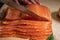 Woman cuts salmon into slices for sandwiches. chopped fresh salmon fillet on a cutting board