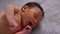 A woman cuts a tag from a newborn boy's hand with nail scissors. Close-up of hands.