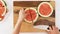Woman cuts watermelon on wooden cutting board