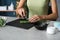 Woman cutting aloe leaf on slate plate