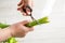 Woman cutting back tulips stems with scissors.