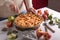 Woman cutting a baked apple with a khife, Thanksgiving traditional dessert ready to eat