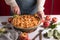 Woman cutting a baked apple with a khife, Thanksgiving traditional dessert ready to eat