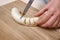 Woman cutting banana into slices close-up of hands