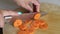 Woman cutting carrot on table, close-up.Hands cutting carrots on a cutting board