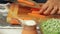 Woman cutting carrots and cooking healthy food at home