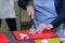 Woman cutting chicken meat on kitchen table