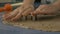 Woman cutting cookies in dough, extreme closeup dolly shot ungraded