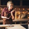 Woman cutting cookies of raw gingerbread dough