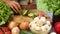 Woman cutting cucumber on a wooden board