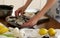 Woman cutting cuttlefish on kitchen table