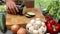 Woman cutting eggplant on a wooden board