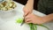 Woman cutting green onion.