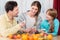 Woman cutting healthy fruits for her husband and daughter