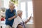 Woman cutting her elderly mother`s hair