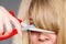 Woman cutting her fringe.