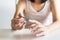 Woman cutting nails with nail clipper,Female using tweezers close up