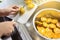 Woman cutting oranges for squeezing and making orange juice