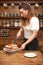 A woman cutting a slice of Victoria sponge cake