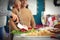 Woman cutting tasty ham during Christmas dinner at home