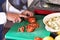 Woman is cutting tomatoes