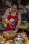 Woman cutting up pork at the street market