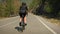 Woman cycling on bicycle on nature. Active healthy lifestyle. Pro female cyclist hard pedaling on bike, pushing pedals, climbing u