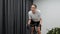 Woman cycling indoors on stationary bicycle. Focused female doing fitness hardio workout on indoor smart cycling trainer,