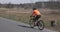 Woman cycling intensively on bicycle. Female riding on road bike. Athlete training hard. Triathlon concept