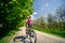 Woman cycling a mountain bike in city park, summer day