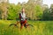 Woman cyclist with bike among the blooming nature