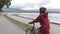 Woman Cyclist biking in Stanley Park by Lions Gate Bridge on Vancouver Seawall