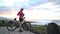 Woman cyclist biking taking selfie using phone while MTB mountain biking