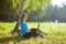 Woman cyclist enjoying relaxation in sunny park