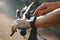 Woman cyclist hands with heart rate icon on smart watch, bicycle at summer trail