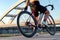 Woman cyclist`s hand checking the bike wheel tire pressure.