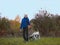 Woman and dalmatian walk autumn evening