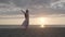 Woman dancing against cloudy sundown sky