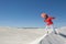 Woman dancing and balancing on sand dune